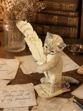 Country Artists Love Story" figurine, a realistic kitten with a  feather